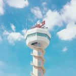 Air traffic control tower against sky background at airport